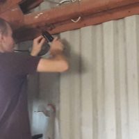 Man installing CCTV on steel building