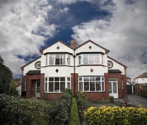 Front View Of Semi Detached House With Privacy Hedge