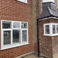 Front view of house with CCTV camera on wall