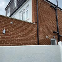 White security camera on side of London home
