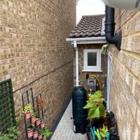 White CCTV camera overlooking side of residential property
